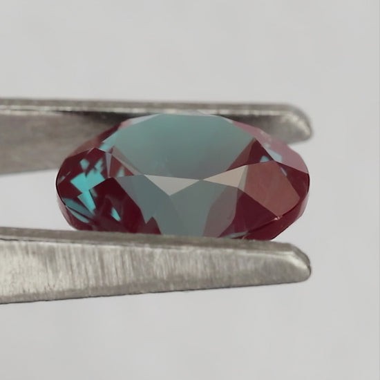 Merchant-finished natural-light video of the round lab-grown alexandrite design, including crown, back and fingertip-scale views.