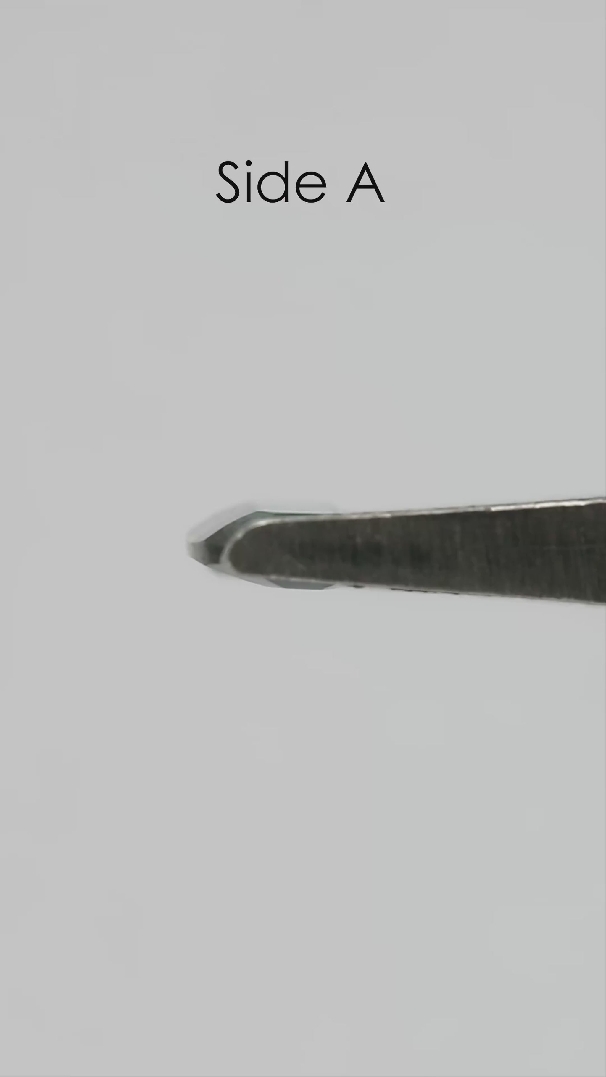Natural-light rotation and fingertip-scale video of the exact green-blue portrait-cut sapphire.