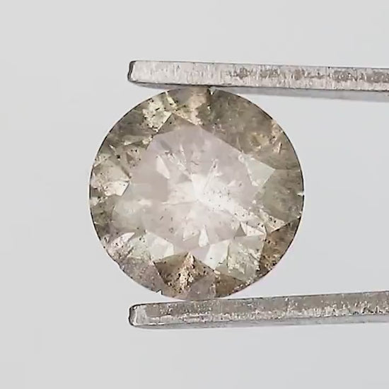 Exact included champagne-brown round diamond turning in tweezers, with face-up, side and pavilion views visible in the reviewed samples.