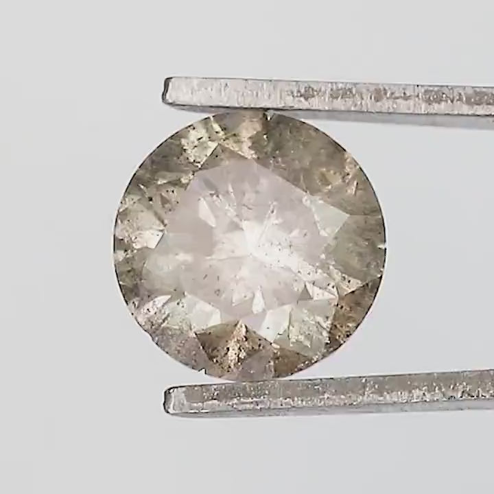 Exact included champagne-brown round diamond turning in tweezers, with face-up, side and pavilion views visible in the reviewed samples.