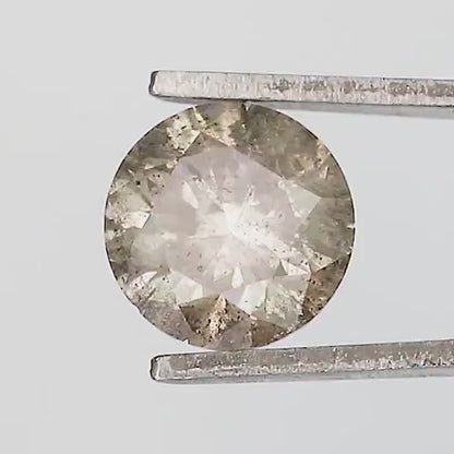 Exact included champagne-brown round diamond turning in tweezers, with face-up, side and pavilion views visible in the reviewed samples.