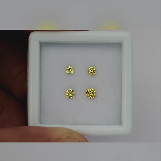Natural canary yellow diamonds shown in motion; purchase contains only the selected pair or individual diamond.