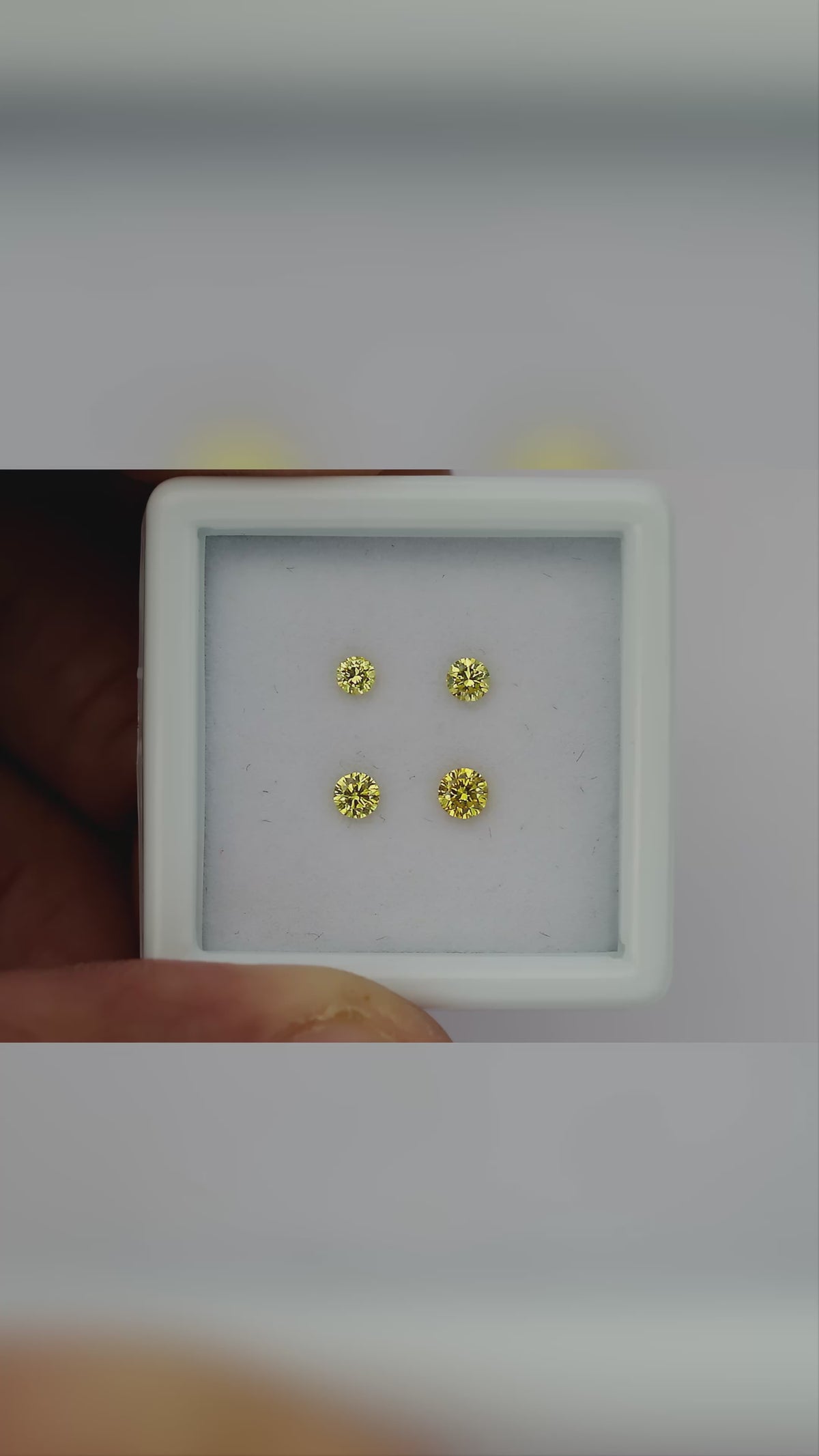 Natural canary yellow diamonds shown in motion; purchase contains only the selected pair or individual diamond.