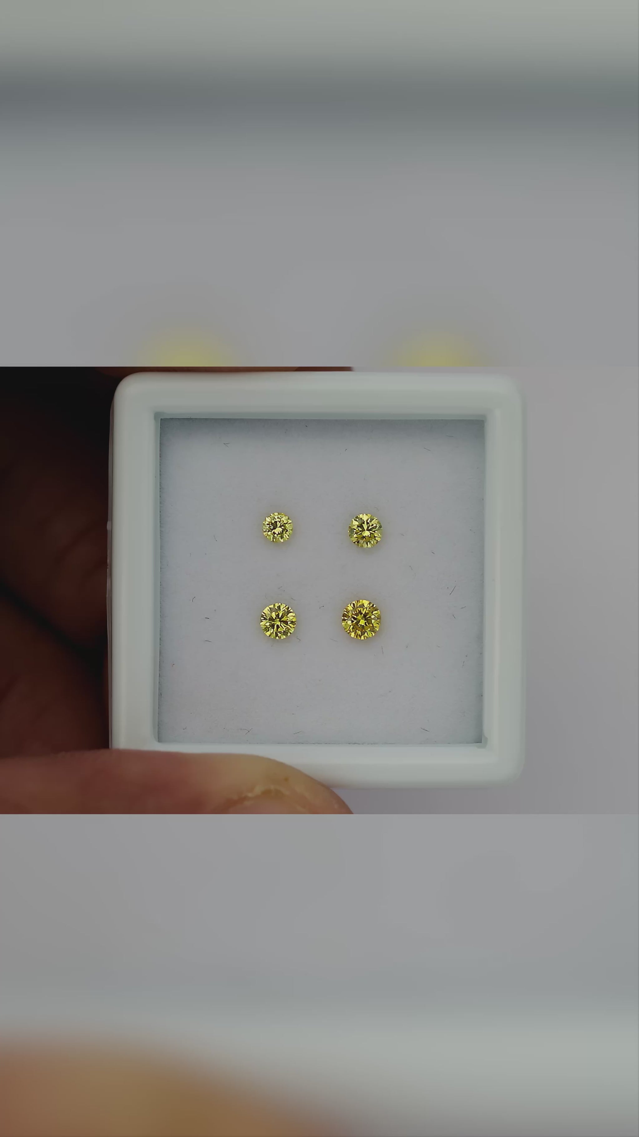 Natural canary yellow diamonds shown in motion; purchase contains only the selected pair or individual diamond.