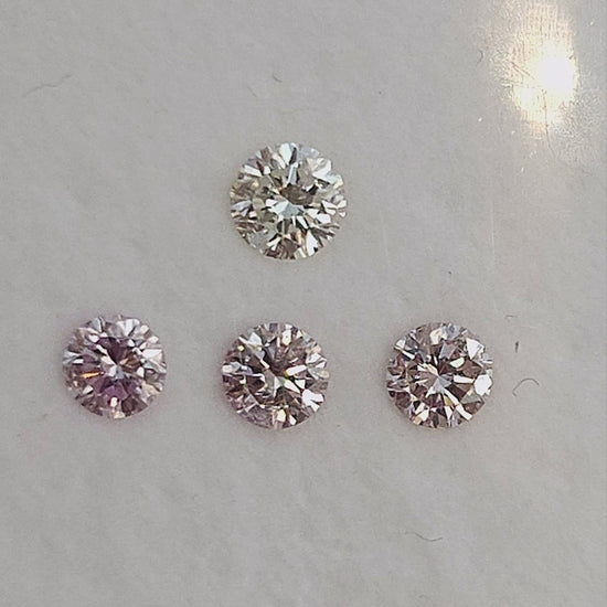 Finished natural-light video of pink round diamond samples with white color references; the group is not the purchase unit.