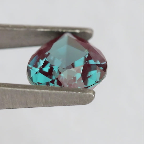 Merchant-finished natural-light video of the pear lab-grown alexandrite design, including crown, back and fingertip-scale views.