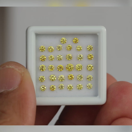Natural canary yellow diamond melee shown in motion; representative material and color, not a guaranteed photographed pack.