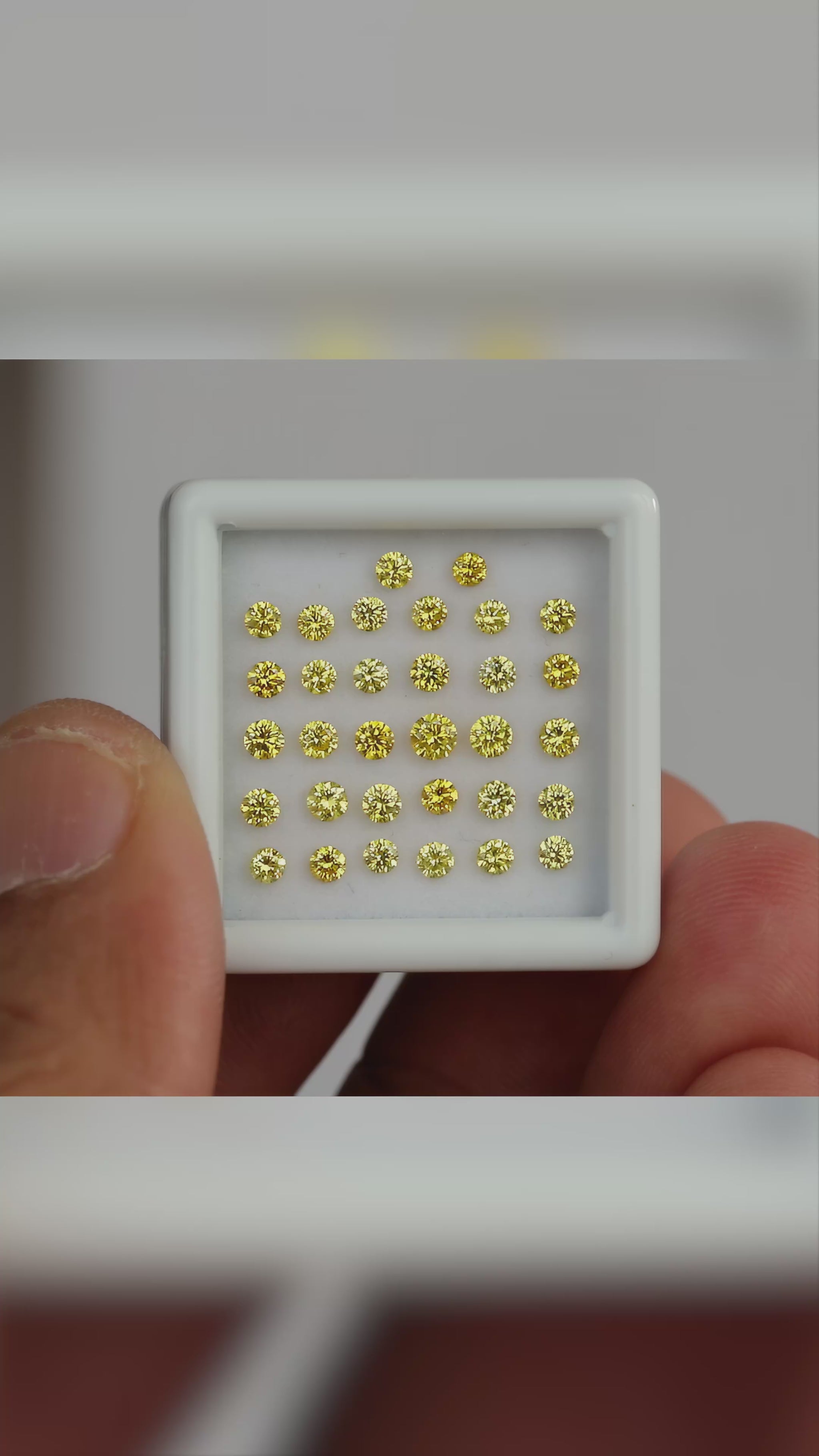 Natural canary yellow diamond melee shown in motion; representative material and color, not a guaranteed photographed pack.