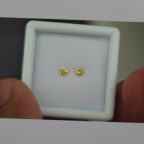 Video of the exact natural canary yellow diamond pair moving in natural daylight
