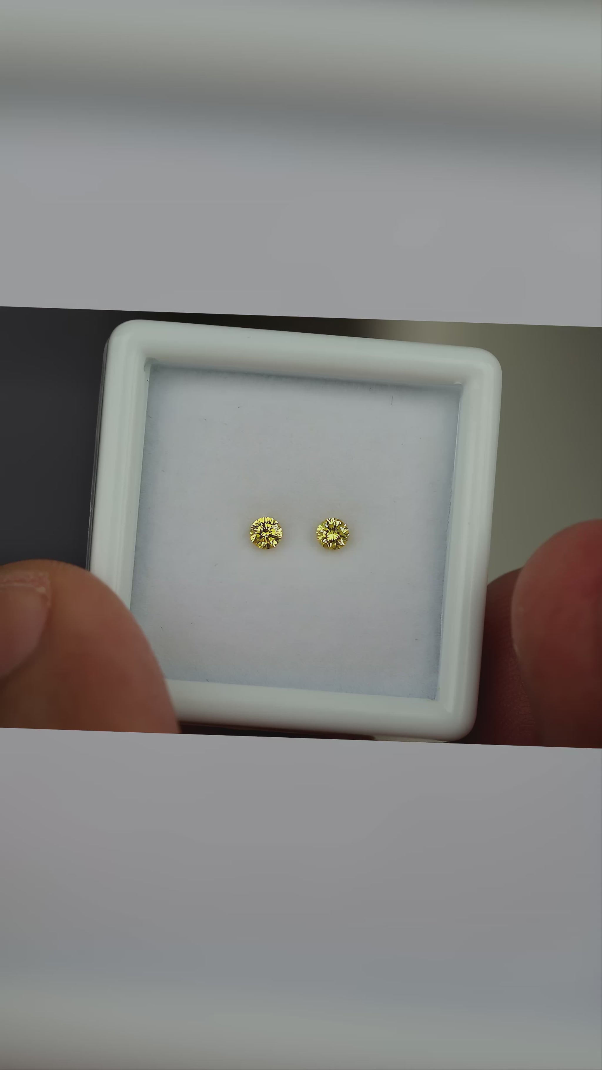 Video of the exact natural canary yellow diamond pair moving in natural daylight