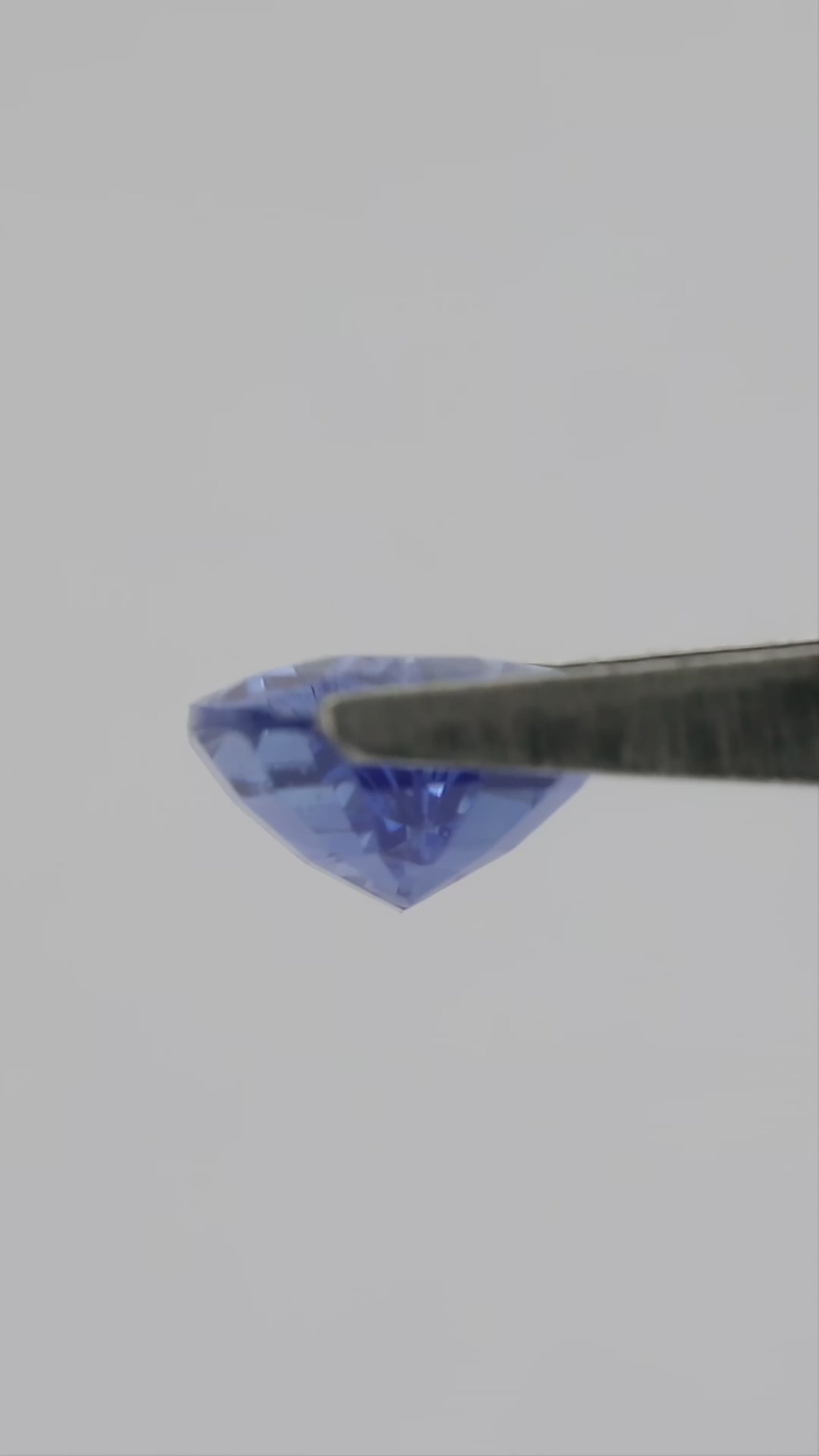 4K natural-daylight video of the exact 1.86 ct violetish blue pear mixed-cut sapphire, showing its face-up color, outline and facet reflections in motion.
