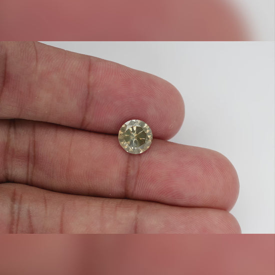 KL444 natural diamond on the hand, shown from wider and closer viewpoints as its face-up reflections change.