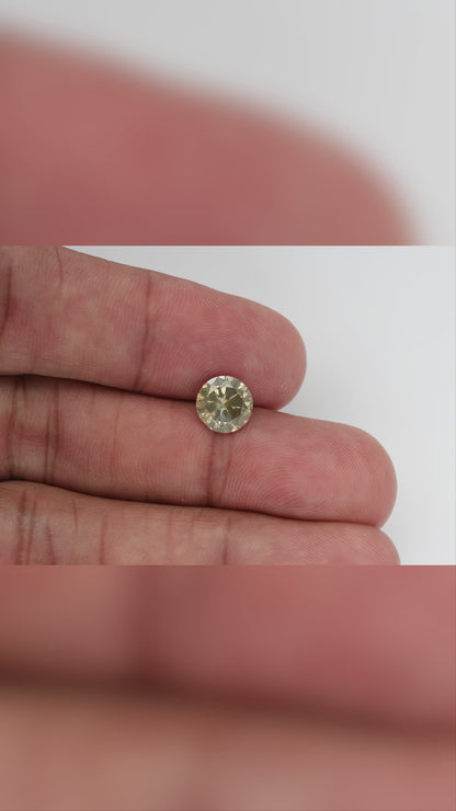 KL444 natural diamond on the hand, shown from wider and closer viewpoints as its face-up reflections change.
