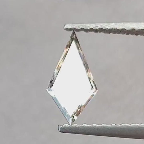 Video of the exact 0.39 ct light champagne elongated kite lab-grown diamond showing its step-cut reflections in motion.