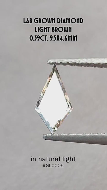 Video of the exact 0.39 ct light champagne elongated kite lab-grown diamond showing its step-cut reflections in motion.