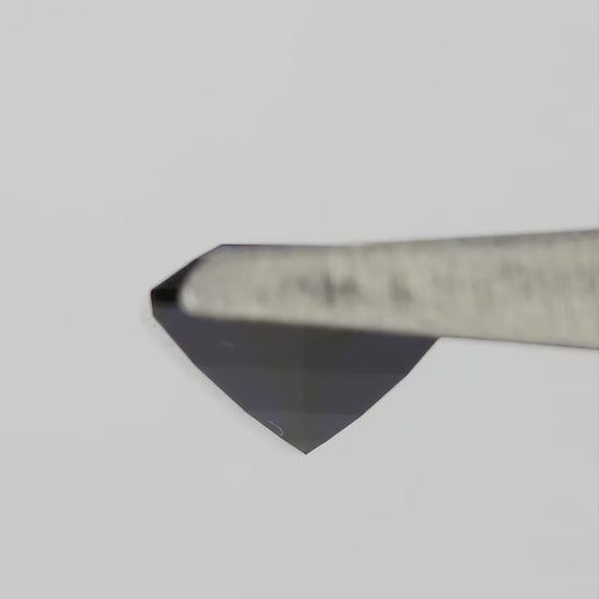 Natural-light rotation and fingertip-scale video of the representative royal-blue lab-grown hexagonal step-cut sapphire.