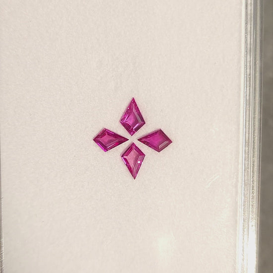 The four pink kite rubies shown together in changing face-up and tilted views of their white tray.