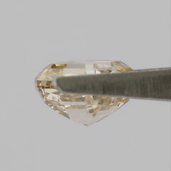 Champagne Asscher-cut diamond shown in tweezers from profile and pavilion angles, followed by finger-held face-up views.