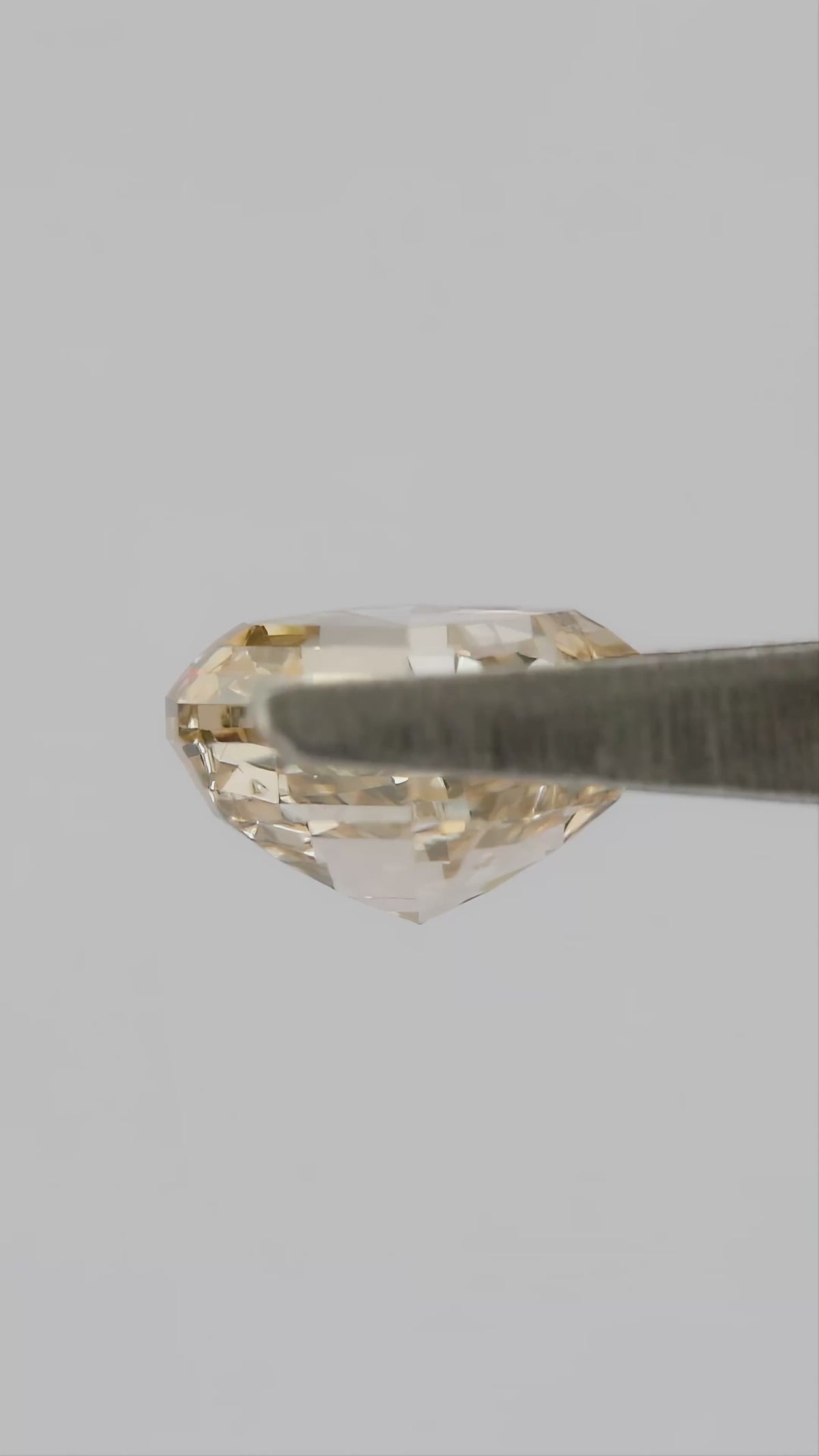 Champagne Asscher-cut diamond shown in tweezers from profile and pavilion angles, followed by finger-held face-up views.
