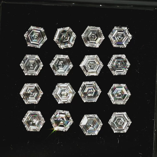 Video showing hexagonal diamonds in a black tray and in a palm, plus an isolated single-diamond close-up, with different step-facet reflections.