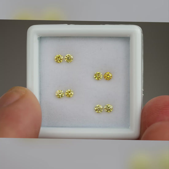 Natural canary yellow diamonds shown in motion; purchase contains only the selected pair or individual diamond.