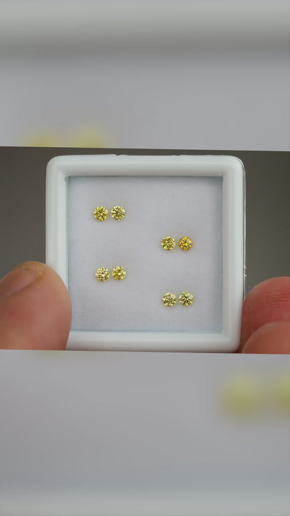 Natural canary yellow diamonds shown in motion; purchase contains only the selected pair or individual diamond.