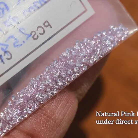 Video showing representative pink round diamonds through changing viewing angles.