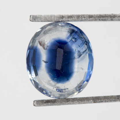 Back view of the oval blue sapphire, showing the pavilion faceting and outline.