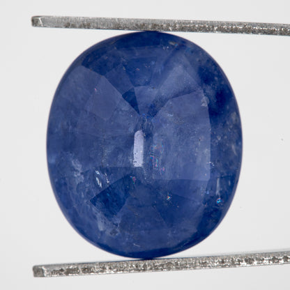 Back view of the oval blue sapphire, showing the pavilion faceting and outline.